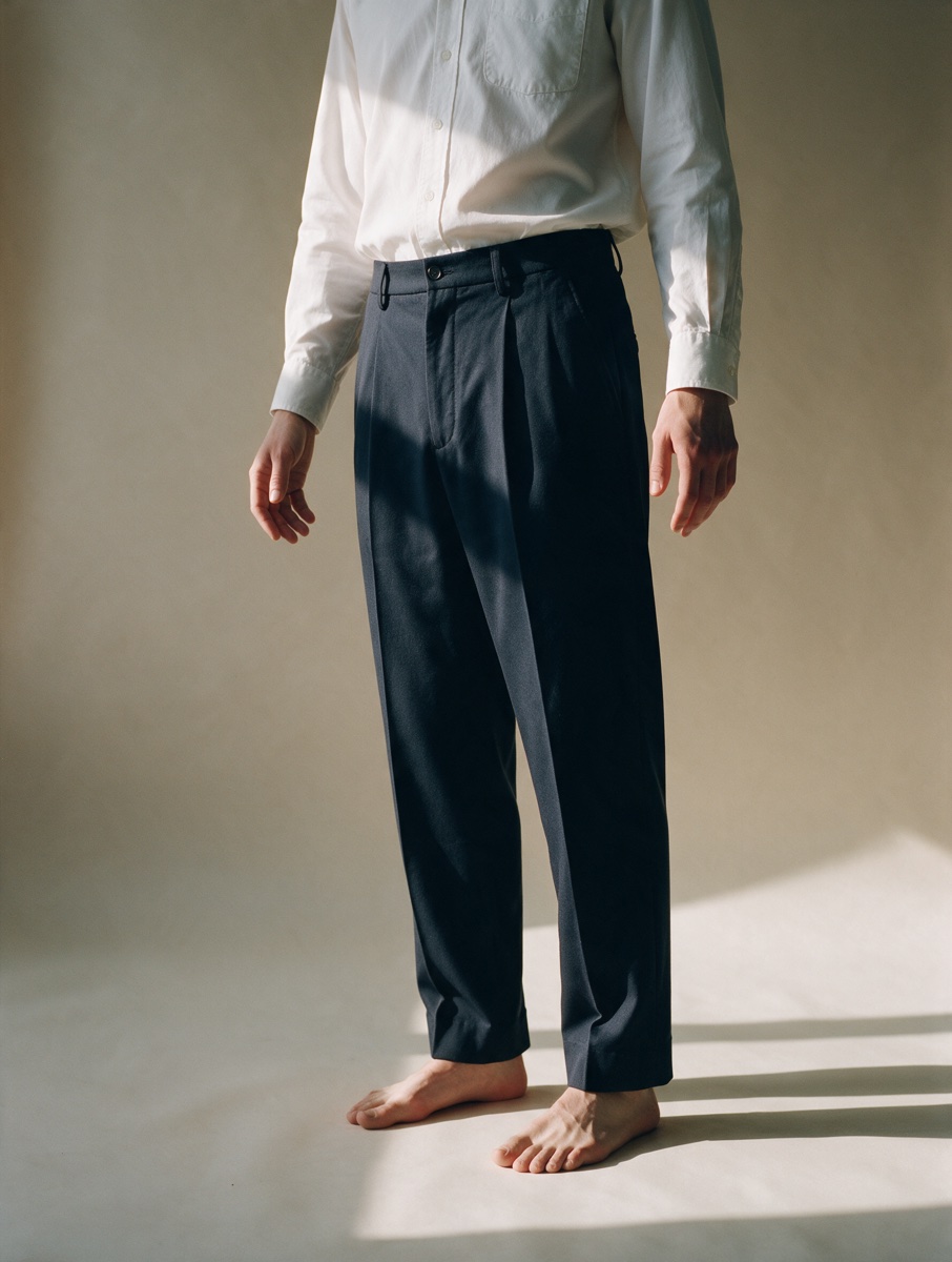 White shirt and navy trousers, worn
